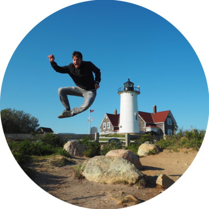 A picture of me jumping in front of a lighthouse